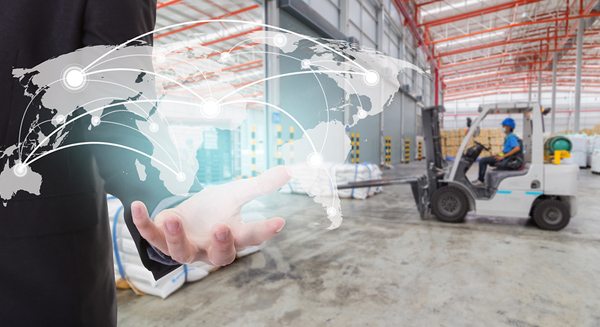 business person holding virtual map inside warehouse facility