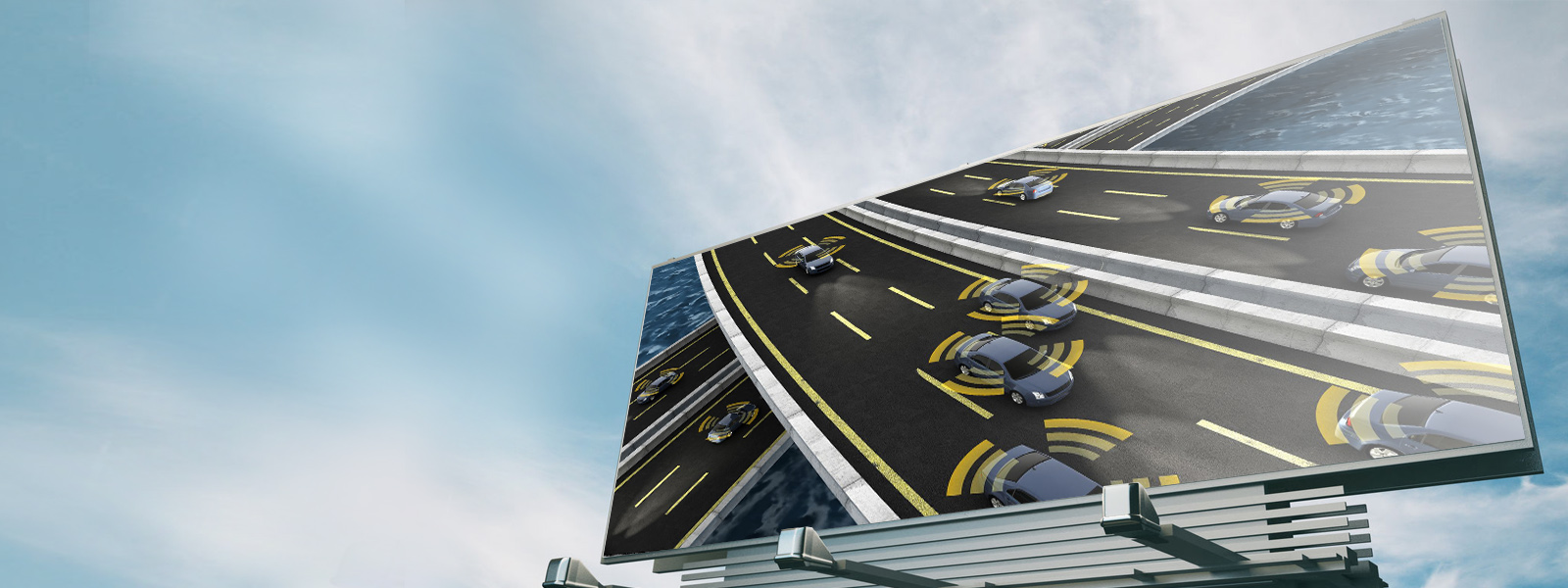 Roadside billboard featuring self-driving cars driving on highway